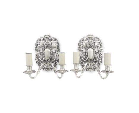 A pair of early 20th century silvered two light wall-sconcesin the Baroque stylethe twin branches terminating in candle nozzl