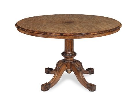 A mid Victorian burr walnut, walnut and tulipwood crossbanded centre table by Gillow and Co.Circa 1870, the oval quarter vene