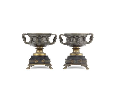 A pair of late 19th century patinated bronze garniture urns cast as models of the Warwick vasesthe pedestal bodies with lion 