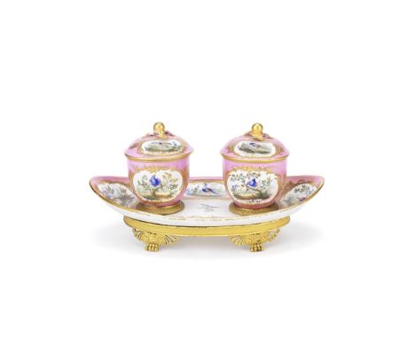 A late 19th century gilt bronze mounted Sèvres-style porcelain encrierof oval boat-shaped form on anthemion paw footed feet, 