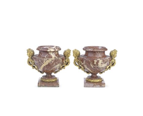 A pair of late 19th/early 20th century French gilt bronze mounted rouge marble pedestal garniture urnsthe squat shouldered bu