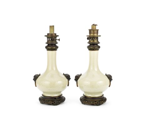 A pair of Chinese porcelain Ge-type bottle vasesmounted as oil lamp bases, the porcelain and French fittings, 19th centuryeac