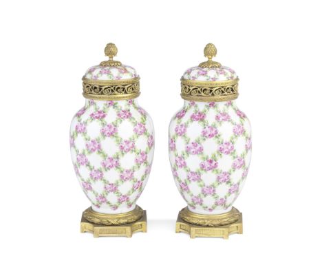 A pair of late 19th / early 20th century French gilt bronze mounted Sevres style porcelain pot-pourri vasesthe white bodies w