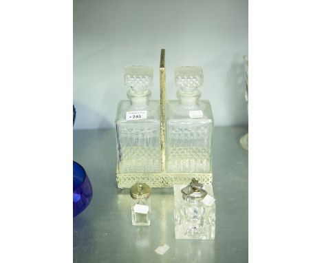 A PAIR OF CUT GLASS DECANTERS IN ELECTROPLATE STANDS, A MUSTARD POT WITH ELECTROPLATE TOP AND A TABLE LIGHTER 