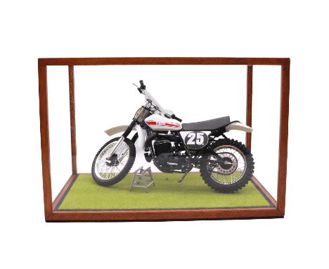 Seven kit built model vehicles, including Yamaha Motorcycle, Traction engine, military jeep, and others, in display cases.