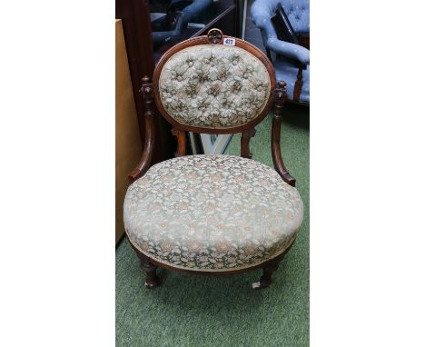 Victorian Upholstered button back low chair on fluted legs and ceramics casters 