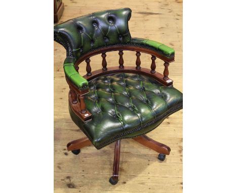 Deep buttoned green leather swivel desk chair