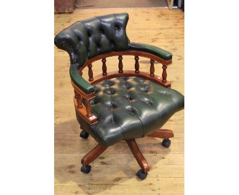 Deep buttoned green leather swivel desk chair