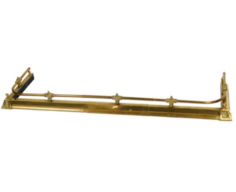 A Victorian brass fender, with a curved gallery, and embossed floral decoration, 148cm wide.