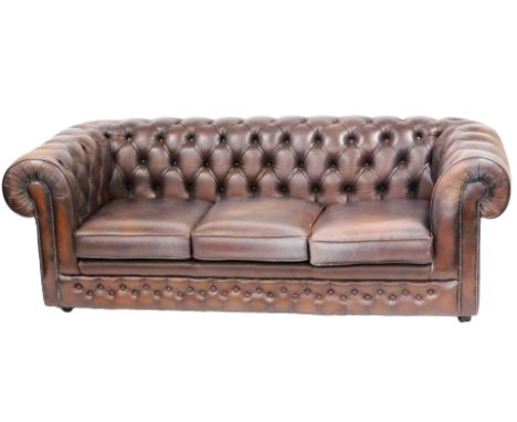 A Thomas Lloyd brown leather three seater Chesterfield sofa, 201cm wide.