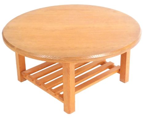 A Stephen Down furniture light oak coffee table, the circular top raised on chamfered square legs, united by a slatted under 