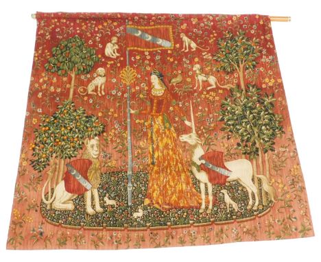 A tapestry wall hanging of The Lion and The Unicorn, with a brass capped wooden pole, 126cm x 132cm.