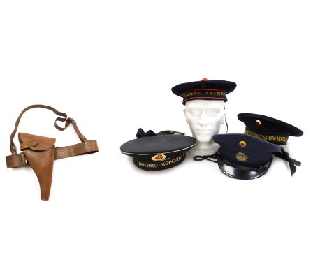 A WWI period British Army Sam Browne belt, with shoulder strap and leather revolver holster, a German, Russian and French mil