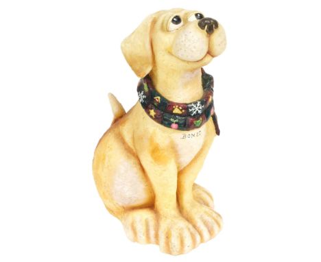 A plaster figure of Bonzo, modelled seat with a scarf around its neck, 84cm high.