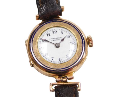 A mid century lady's 9ct rose gold cased wristwatch, with blue enamel line decoration, circular white dial bearing Arabic num