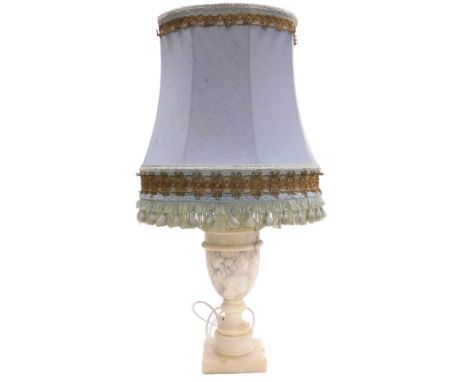An alabaster table lamp, of vase and cover form, raised on a square base, with a blue fabric shade, 54cm high. Buyer Note: WA