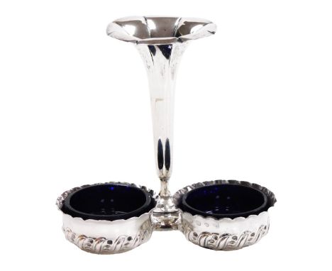 A pair of Victorian silver circular salts, with embossed scroll decoration, and unmatched blue glass liners, Vale Brothers &a