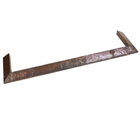 An Arts and Crafts copper fender, with embossed stylised floral and foliate decoration, 135cm wide. 