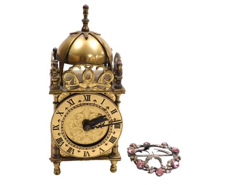 A 20thC Smiths brass lantern clock, chapter ring bearing Roman numerals, with electric movement, 18cm high, and an early 20th