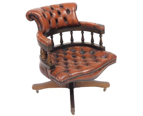 A oak and tan leather captain's chair, with button back and seat, raised on a x frame support, 61cm wide.