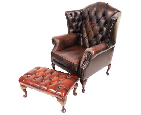 A brown leather wing back armchair, with button back and drop in seat, raised on carbiole legs, 95cm wide, together with a fo