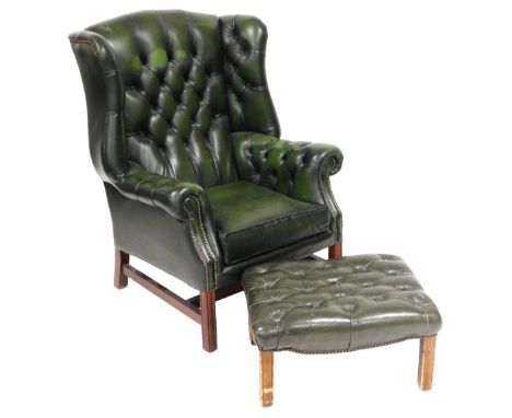 A green leather wing back armchair, with button back, and loose cushion seat, raised on square legs, 78cm wide, together with