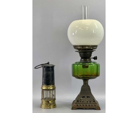 OIL LAMP - late 19th century with pierced cast iron base, circular green glass reservoir, twin burner and opaque globular gla