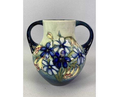 MOORCROFT VASE - of pear shape two handled form, tube lined in the 'Spring Flowers' pattern, on a light and dark blue ground,
