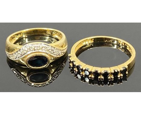 18CT GOLD DRESS RINGS (2) - the first having an inline setting of eight claw mounted black stones, possibly facet cut jet, Si