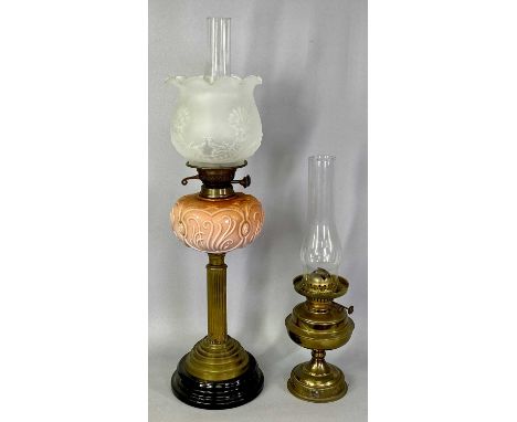 OIL LAMPS (2) - late 19th century, with black ceramic base, fluted brass column, moulded pink opaque glass reservoir, twin bu