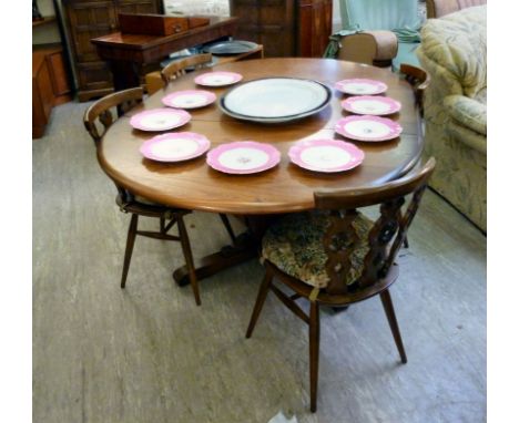 A modern Ercol 'Golden Dawn' extending dining table, the top raised on a cross-over splayed underframe  28''h  45''dia extend