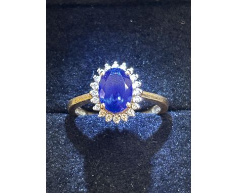 18ct Gold ring set with central sapphire surrounded by 20 diamonds Size R 4.7g 