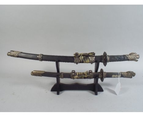 A Modern Reproduction of Two Japanese Swords on Stand. 