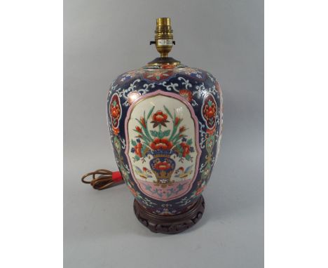 A Large Oriental Jar Decorated with Polychrome Enamels Converted into A Table Lamp with Stand.