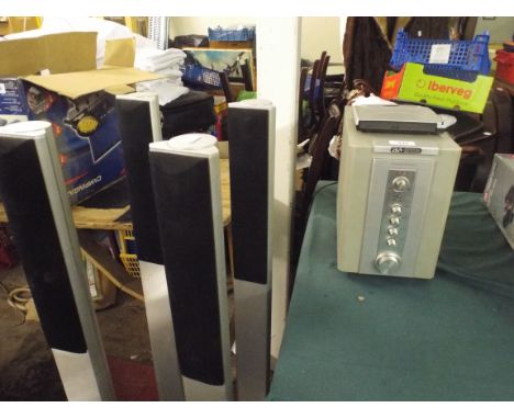An Acoustic Solutions Amplifier with Four Floor Standing Speakers. 