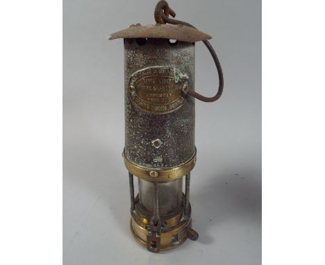 A Brass Mounted Miners Lamp by Davis Kirk Limited. 