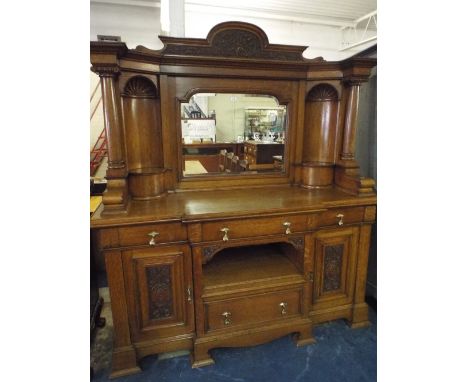 A Late Victorian Breakfront Oak Mirror Back Sideboard, The Base with Centre Upper and Lower Drawers and Centre Recess Flanked