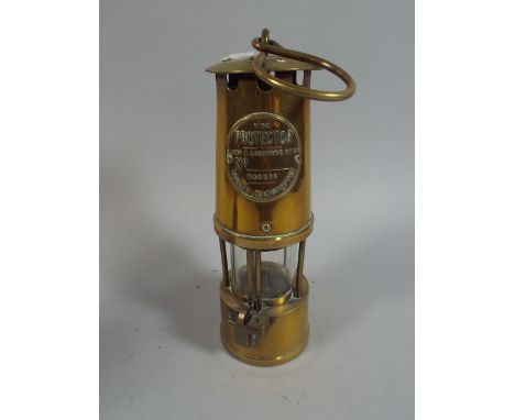 A Brass Miners Lamp by The Protector Lamp and Lighting Company Limited.