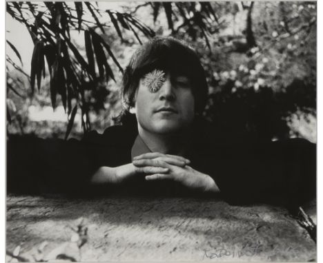 Robert Whitaker, British, 1939-2011- John Lennon with flower, Weybridge, 1965; photographic print in black and white on smoot
