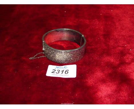 A Silver engraved and hinged Bangle with safety chain, Birmingham 1937, Meyer Ltd.