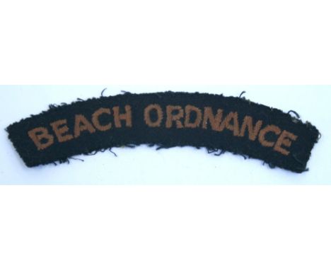 Scarce WW2 Beach Ordnance Cloth Shoulder Title, being a curved dark navy blue cloth title with red wording. Uniform removed e