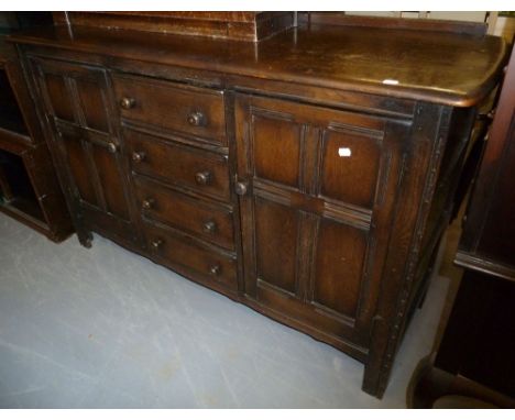 ERCOL GOLDEN DAWN ELM SIDEBOARD WITH A NEST OF FOUR CENTRE DRAWERS AND FLANKED BY TWO CUPBOARDS, 58" (107.3cm) WIDE, 35 1/2" 