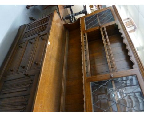 JACOBEAN STYLE OAK WELSH DRESSER, THE RAISED BACK HAVING TWO GALLERIED PLATE RACKS, FLANKED BY TWO CUPBOARDS AND WITH LEAD LI