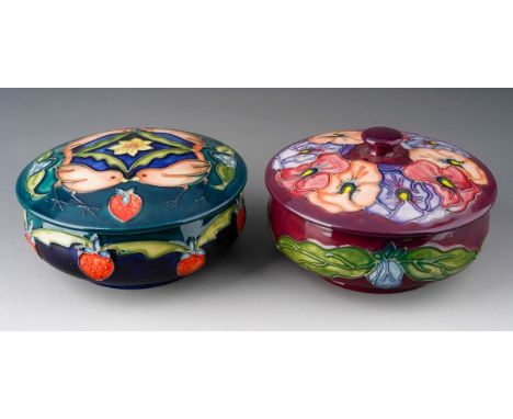 A Moorcroft Strawberry Thief powder / trinket box and cover, navy blue ground impressed and a matching Moorcroft Pansy box an