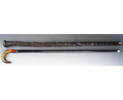 Two various walking sticks, the gnarled wood example with Asian white metal mount chased with a dragon, stamped PC 90, the ot