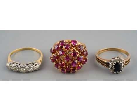 Three diamond and gem set rings. The first set with five round brilliant cut diamonds, together with a sapphire cluster ring 