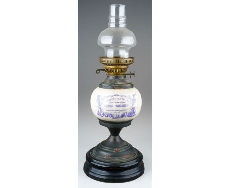 A reproduction Victorian style ceramic and brass oil style table lamp, the ceramic reservoir printed 'Mortar Bluepill....', w