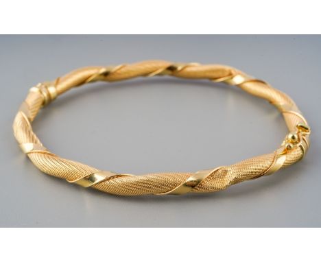 A hinged bangle. Designed as a mesh design bangle with plain polished detail, bangle stamped 750, together with Italian marks