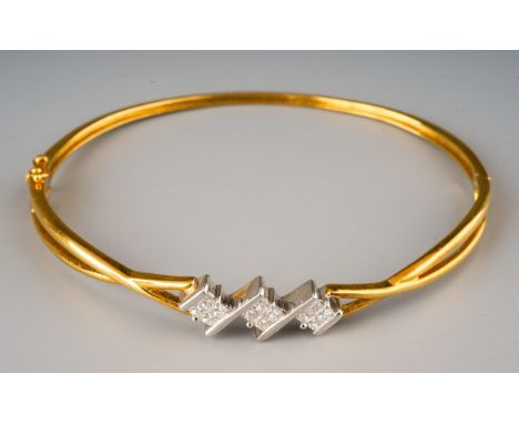A diamond hinged bangle. Set with princess cut diamonds, estimated / stated diamond weight 0.54cts, stamped 750 054, gross we