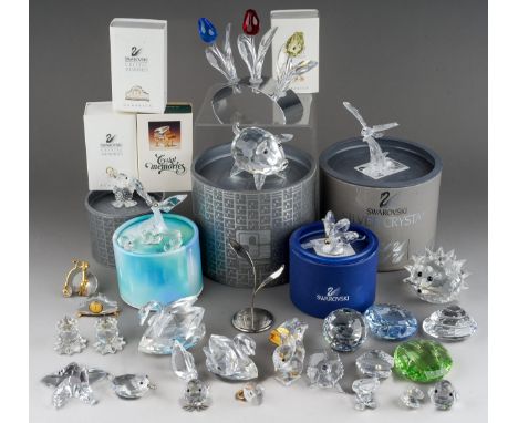 A collection of boxed and loose Swarovski Crystal miniatures and other Swarovski Crystal items, including animals, three tuli